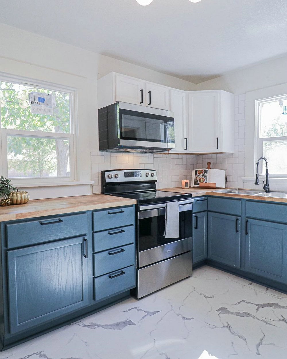 blue kitchen cabinets with butcher block countertops