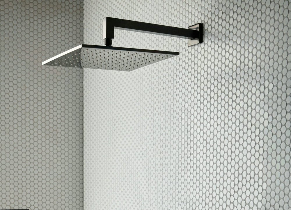 white penny tile with black grout feature