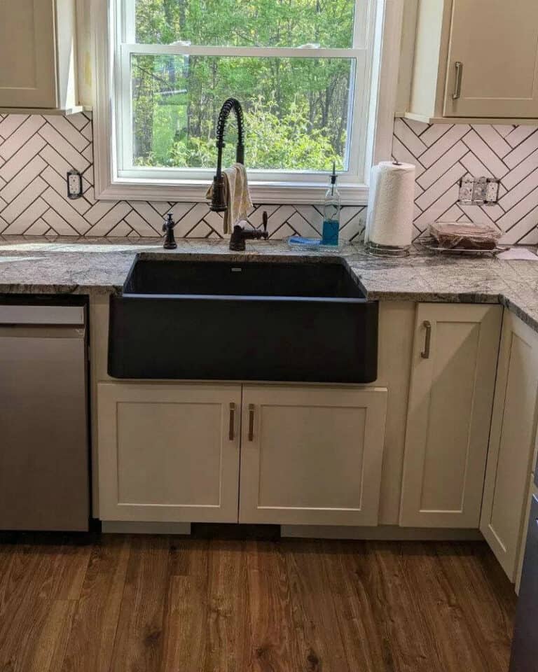 white herringbone backsplash with black grout feature