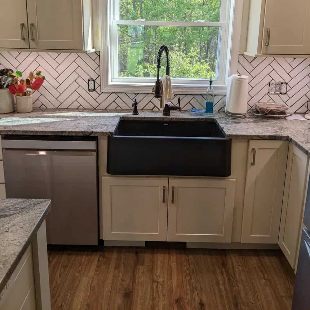 white herringbone backsplash with black grout