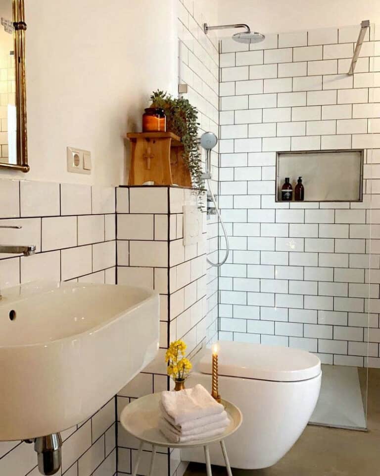 white subway tile bathroom with black grout feature