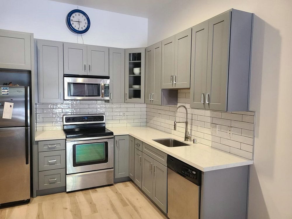 white subway tile backsplash with grey grout