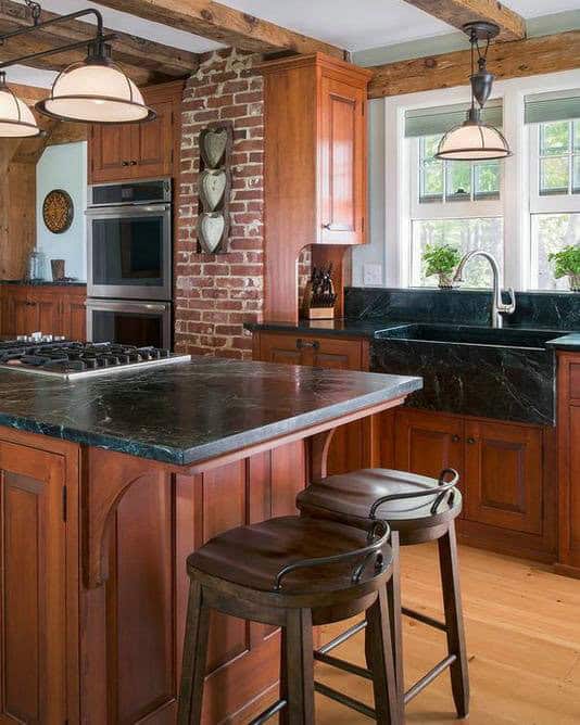 backsplash with cherry cabinets and black granite feature