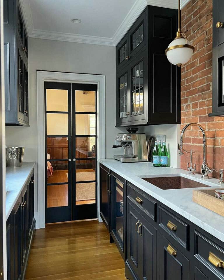 black cabinets brick backsplash feature