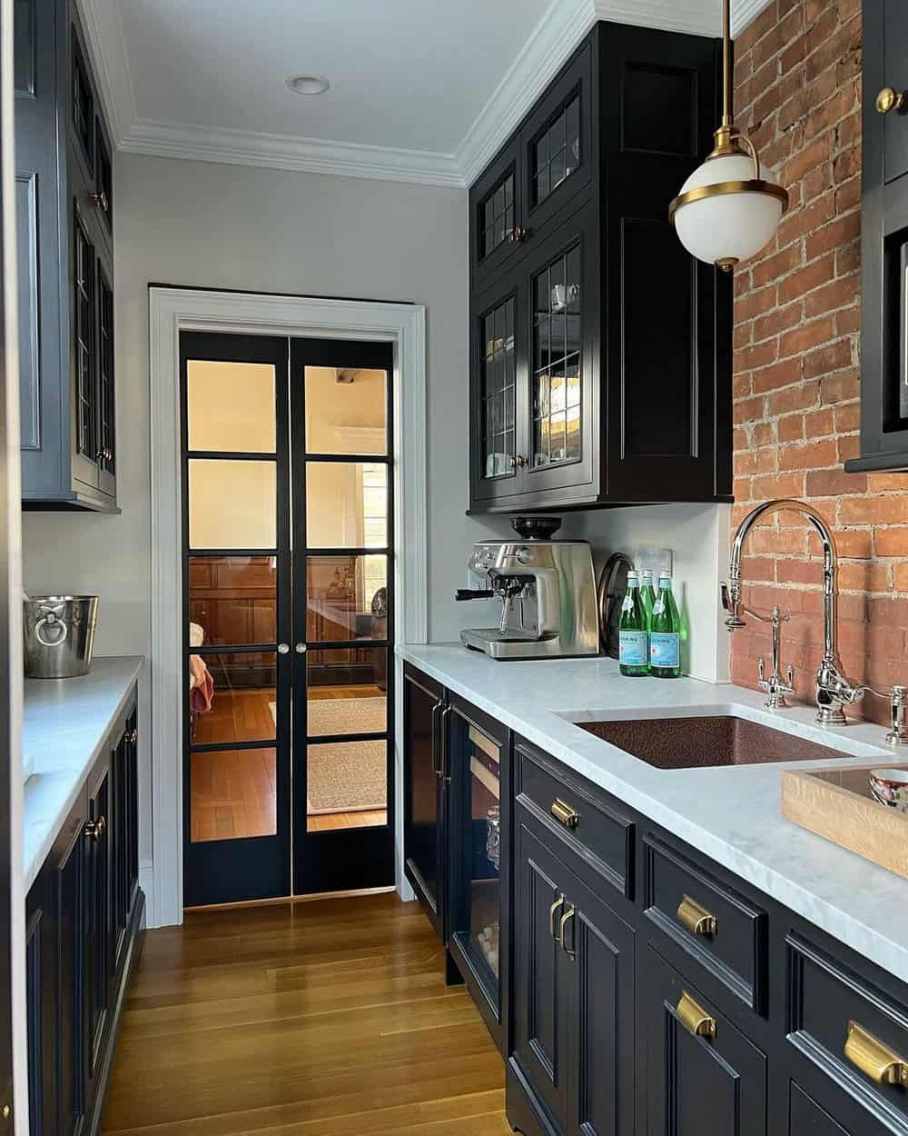 black cabinets brick backsplash