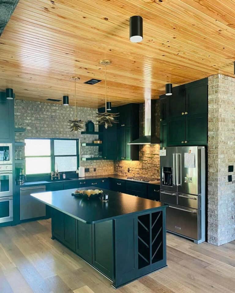 black cabinets with brick backsplash feature