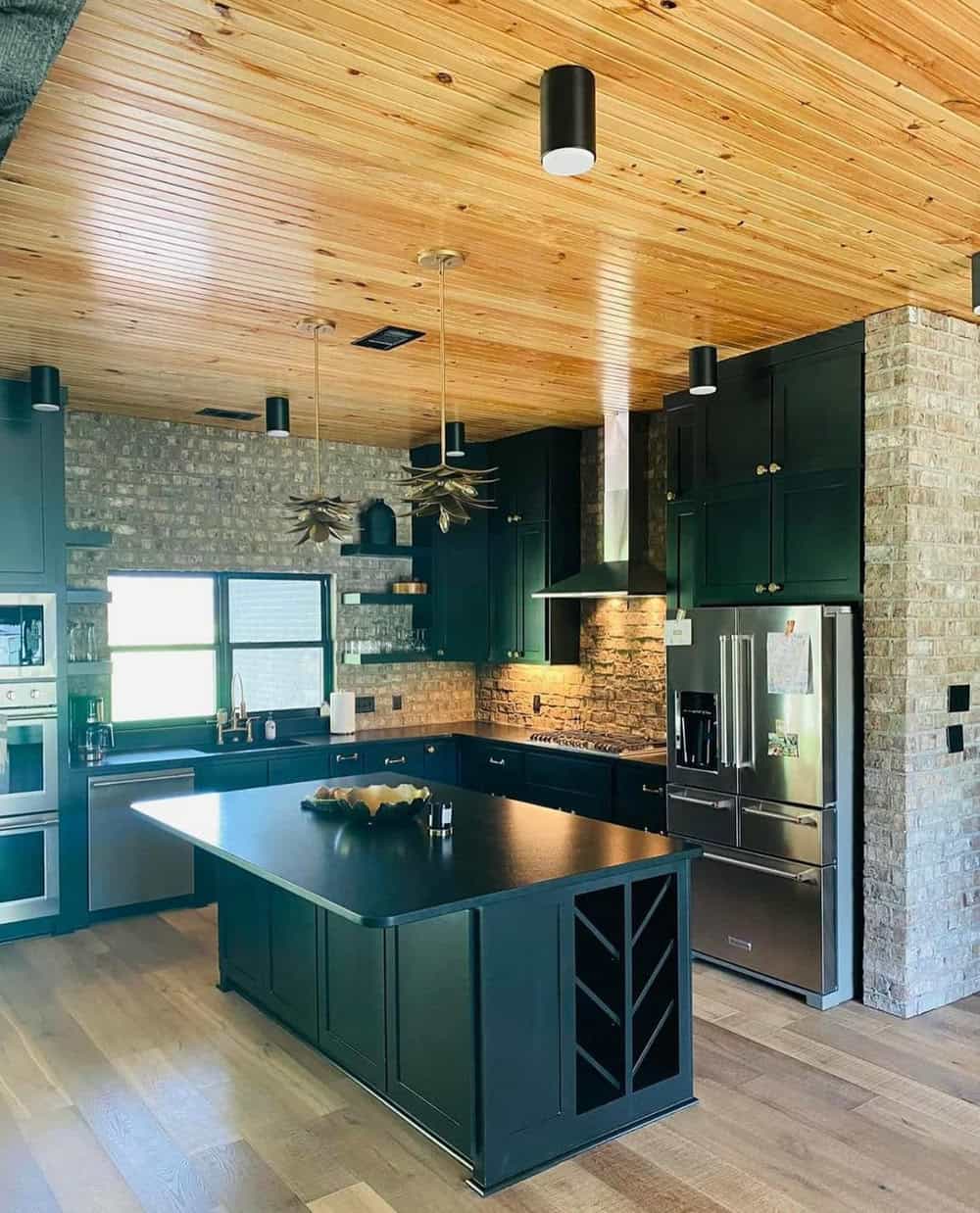 black cabinets with brick backsplash