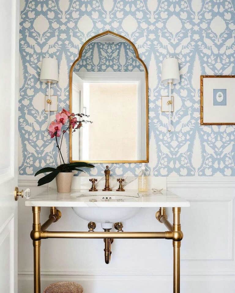 powder room with wainscoting and wallpaper feature