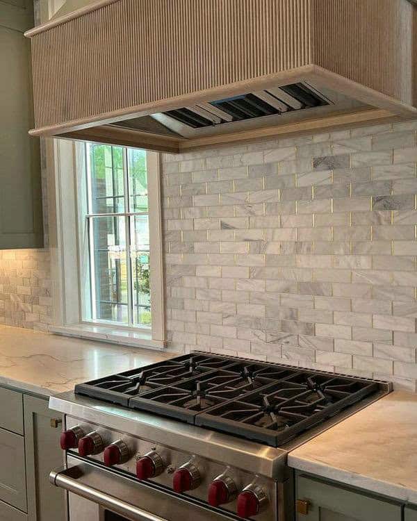 white subway tile gold grout feature