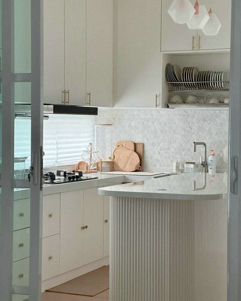 white kitchen cabinets with white countertops and white backsplash feature