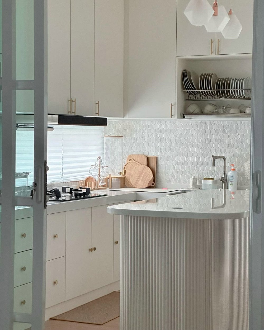 white kitchen cabinets with white countertops and white backsplash