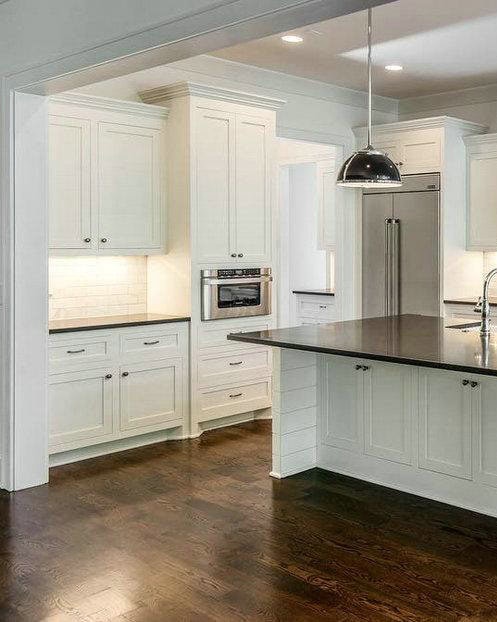 white shaker cabinets with black countertops feature