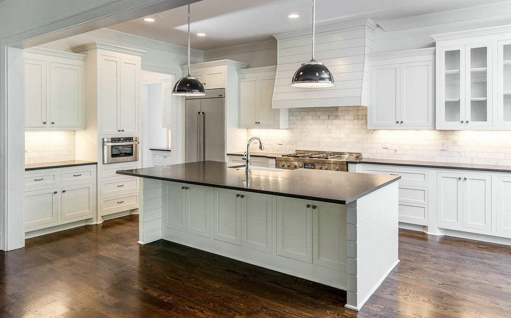 white shaker cabinets with black countertops