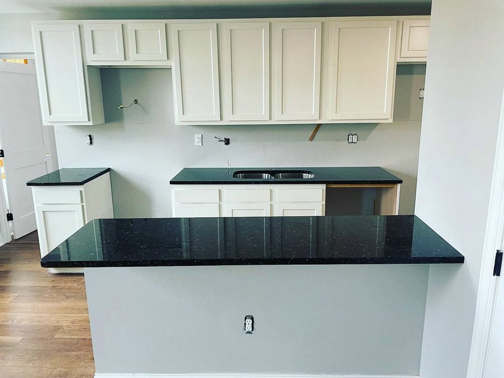 verde butterfly granite with white cabinets