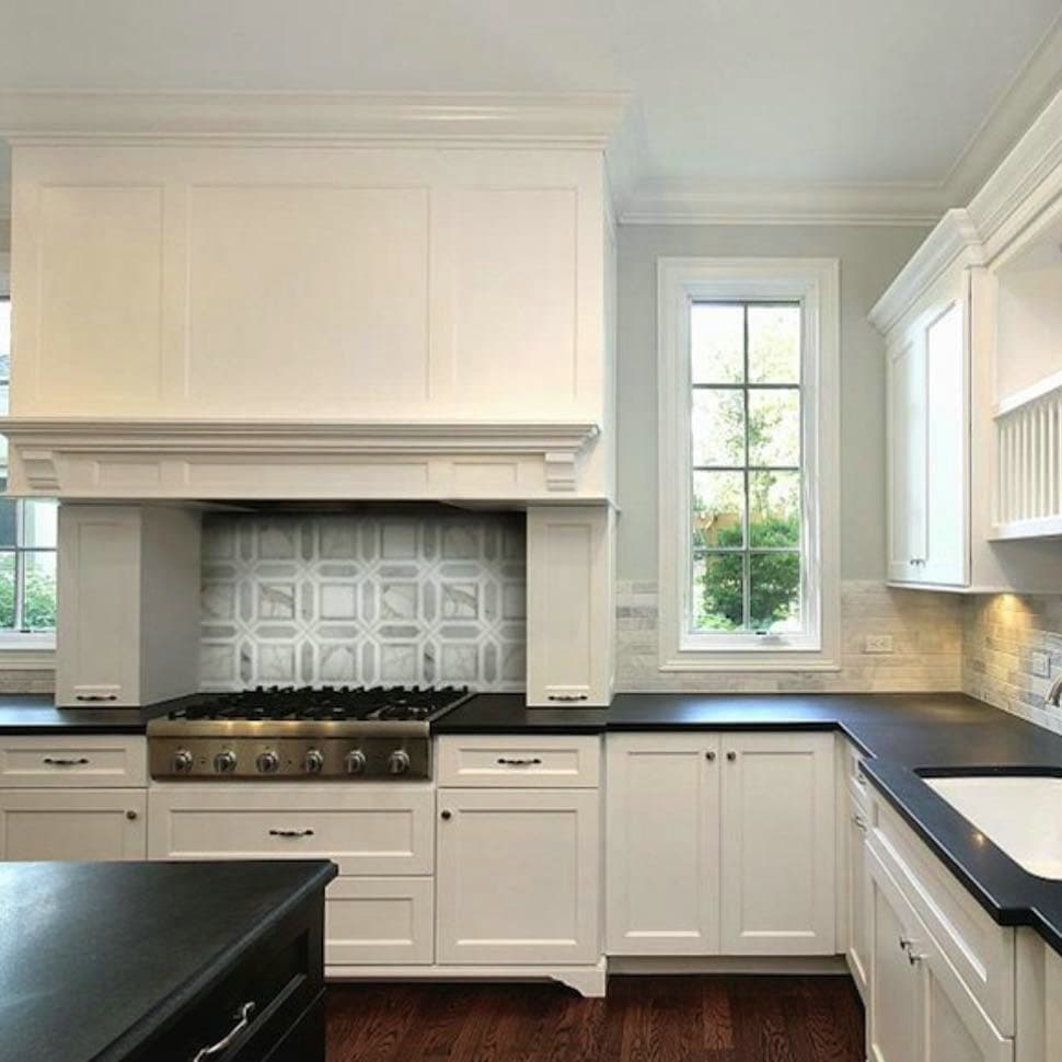 kitchen backsplash with black granite countertops and white cabinets