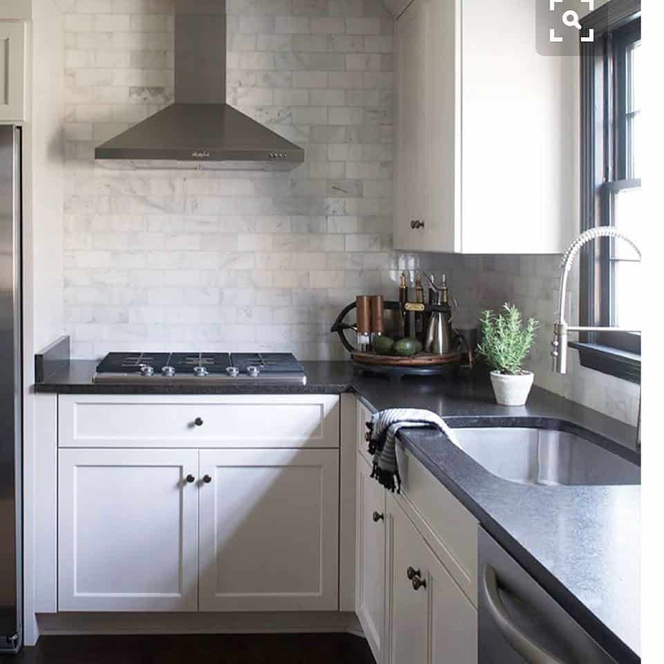 dark gray backsplash white cabinets