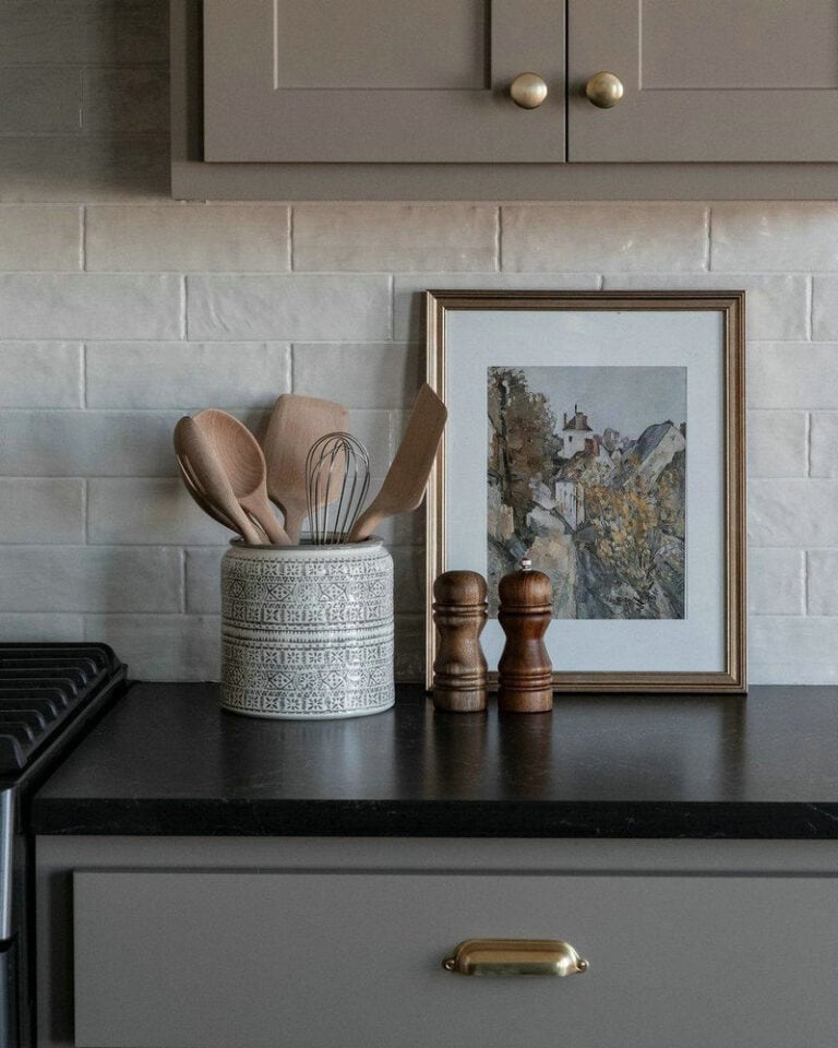 light grey kitchen cabinets with black granite countertops feature