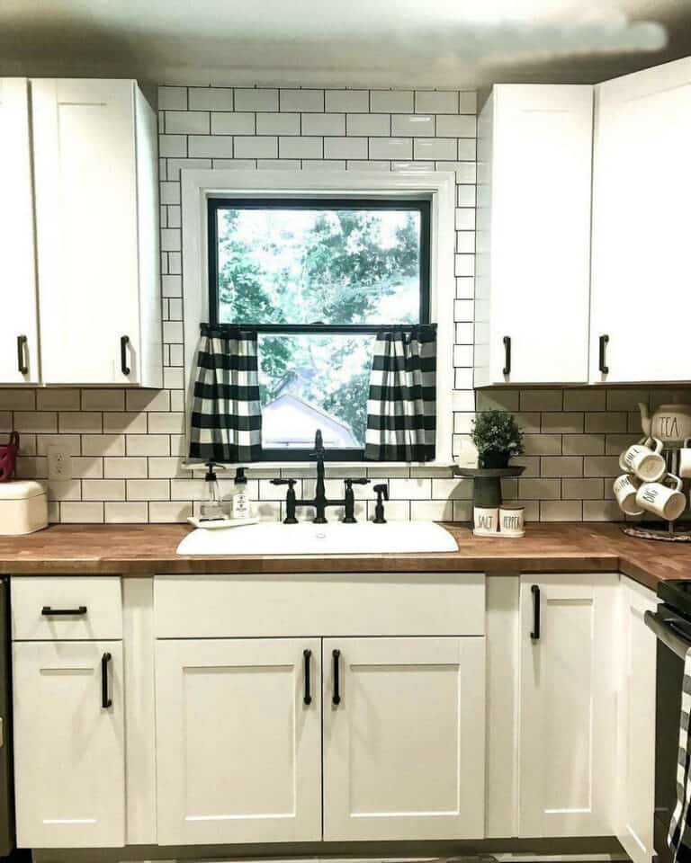 subway tile black grout kitchen feature