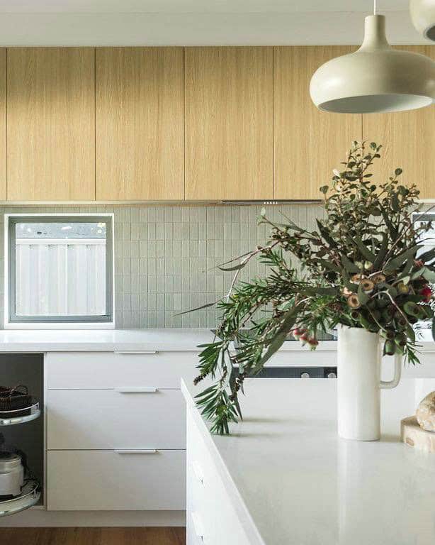 light gray subway tile kitchen feature