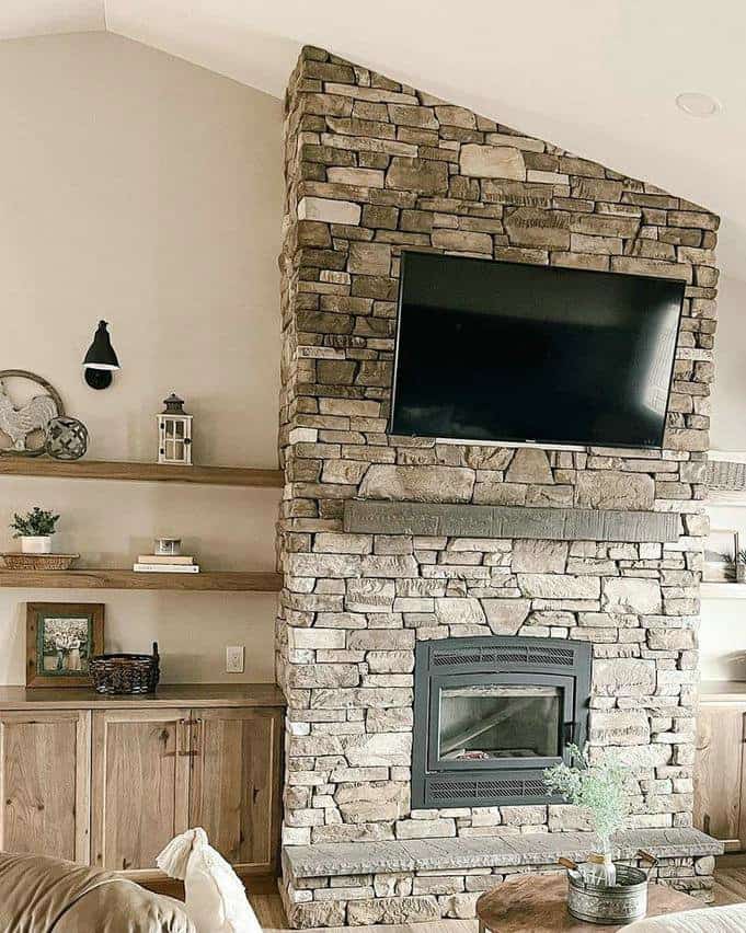 stone fireplace with bookshelves on each side feature