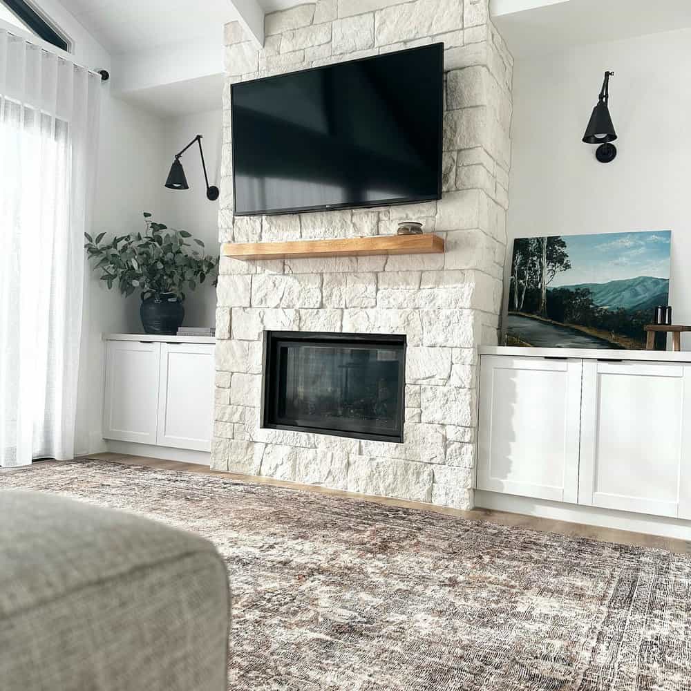 floor to ceiling stone fireplace with tv