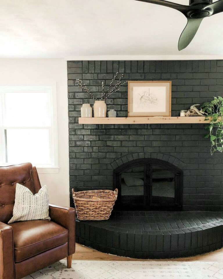 black brick fireplace with white mantel feature