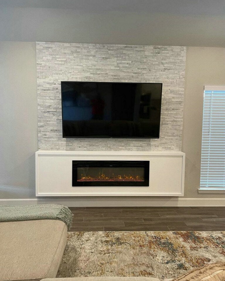 electric fireplace with mantel and tv above feature