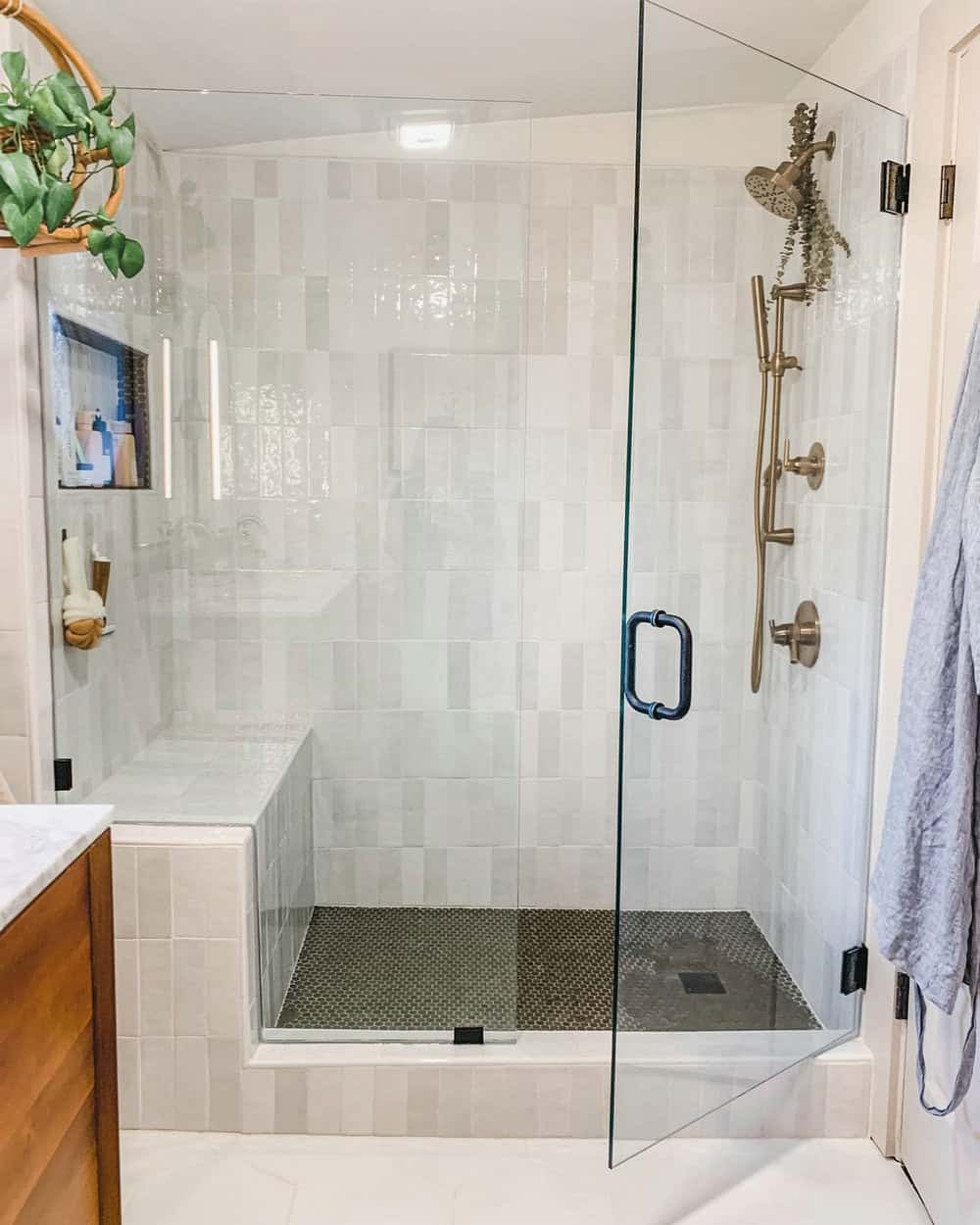 white subway tile shower with niche