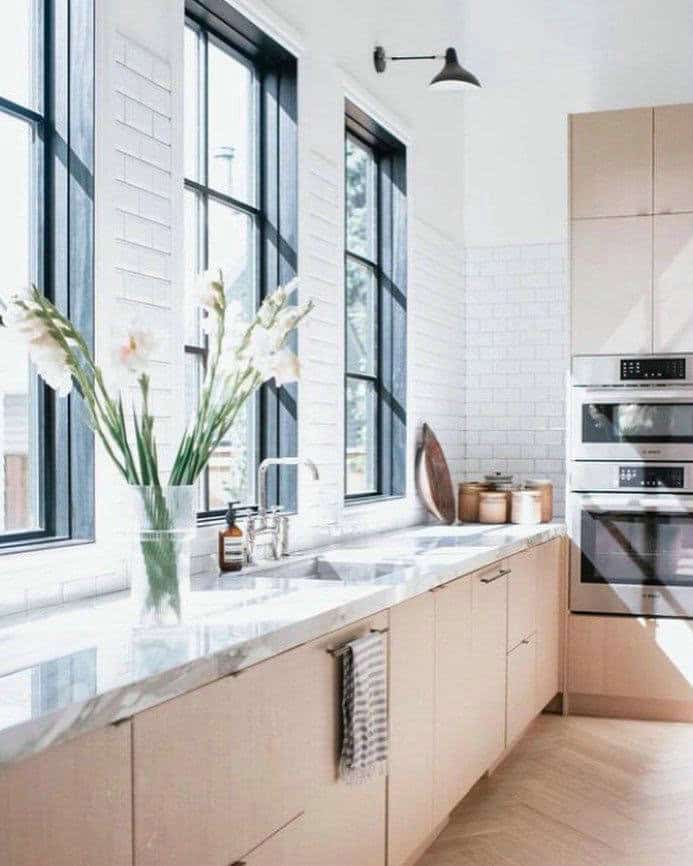 white subway tile around kitchen window feature