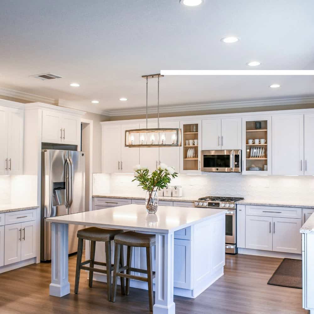 white kitchen cabinets with white countertops and white backsplash