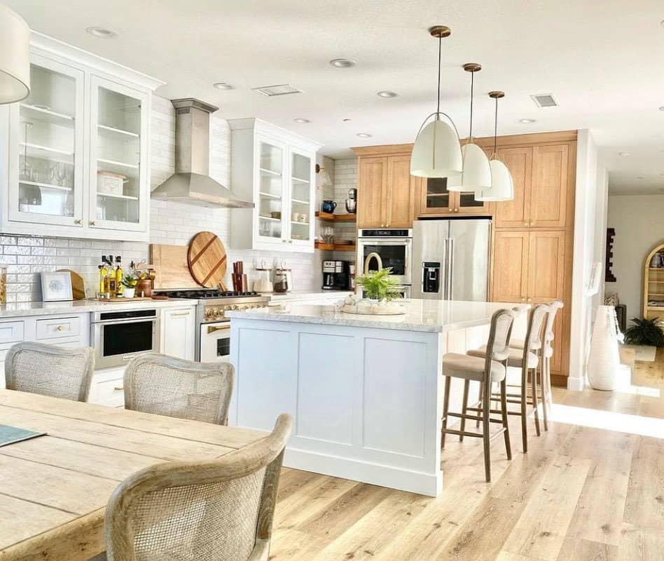 Two-toned cabinets paired with wood floors make for a ravishing farmhouse style kitchen
