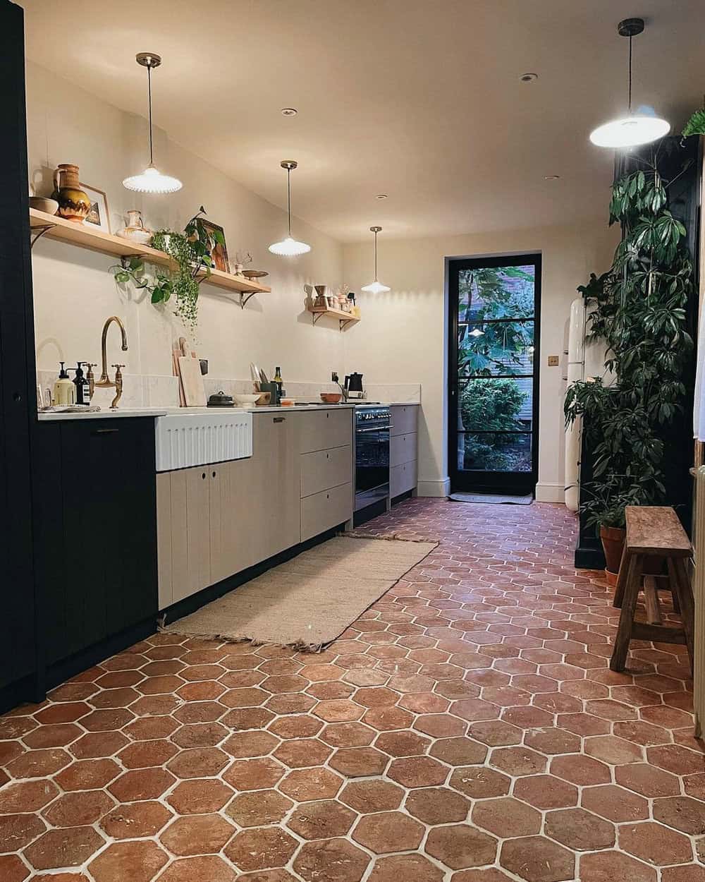 Honeycomb terra cotta tile floors are a focal point of this kitchen style