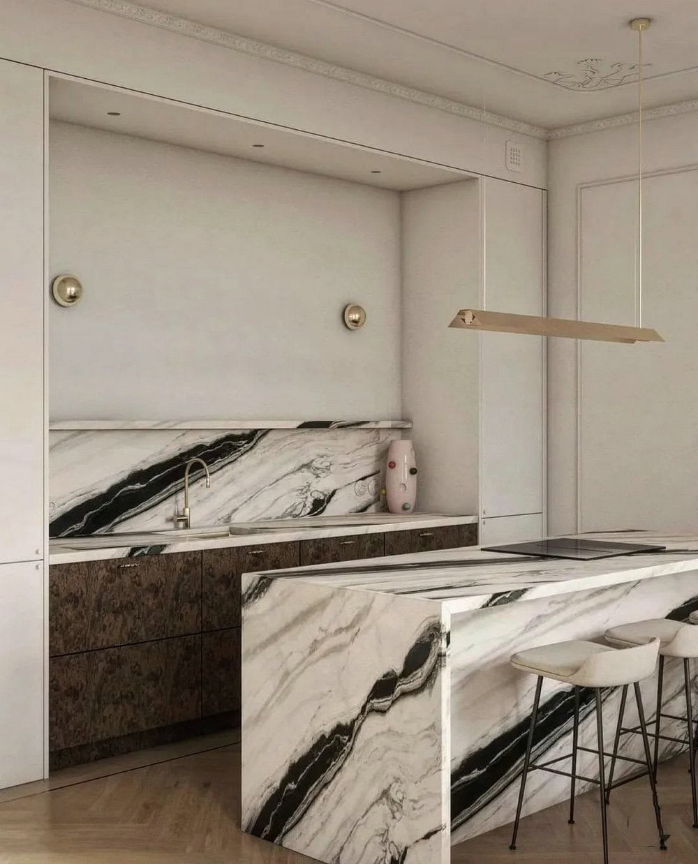 Luxurious marble kitchen with sleek black and white veining, complemented by modern bar stools and subtle lighting.