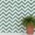 Green and white chevron tile installed on a kitchen backsplash wall