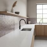 Glass tile backsplash with iridescent finish in contemporary kitchen setting.