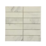 White marble tile with subtle gray veining and smooth texture.