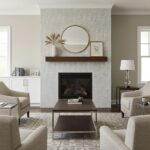 A cozy living room featuring a fireplace with a geometric patterned tile wall in neutral tones, complemented by contemporary.