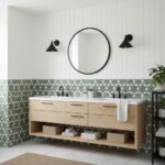 A modern bathroom with peel and stick wall tiles, a large round mirror, and black wall sconces for a stylish look.