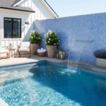 Beautiful blue glass tile backsplash with water feature.