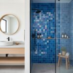 Blue glass tile backsplash for bathroom shower with mosaic details.