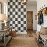 Bright, textured interior with rustic wood furniture and a bold black-and-white geometric tile accent wall.