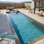 Pool with glass tile backsplash and mosaic accents for a sleek, contemporary look.