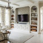 Decorative pearl tile wall with seashell accents in a cozy, bright living room setting.