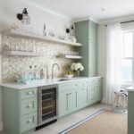 Bright kitchen with peel and stick tile backsplash and pastel cabinetry.