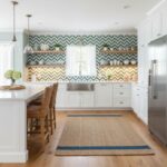 Kitchen wall with peel and stick tile backsplash and open shelves.