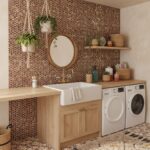 Stylish laundry room featuring a wall with mother of pearl shell tile behind the sink and washing machine.
