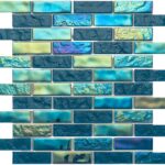 Colorful glass tile mosaic featuring various shades of blue and iridescent finishes, ideal for backsplashes and pool areas.
