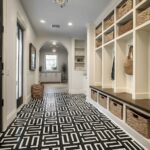Black and white geometric patterned tile with a textured surface, used as flooring in a modern entryway.