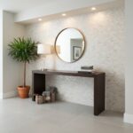 A stylish interior with a pearl shell tile wall, round mirror, and modern console table, creating a sophisticated and elegant.