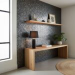Modern interior with peel and stick tile wall behind a wooden console and floating shelf.